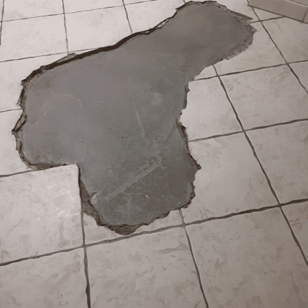 Cracked tile in the middle of floor before repair