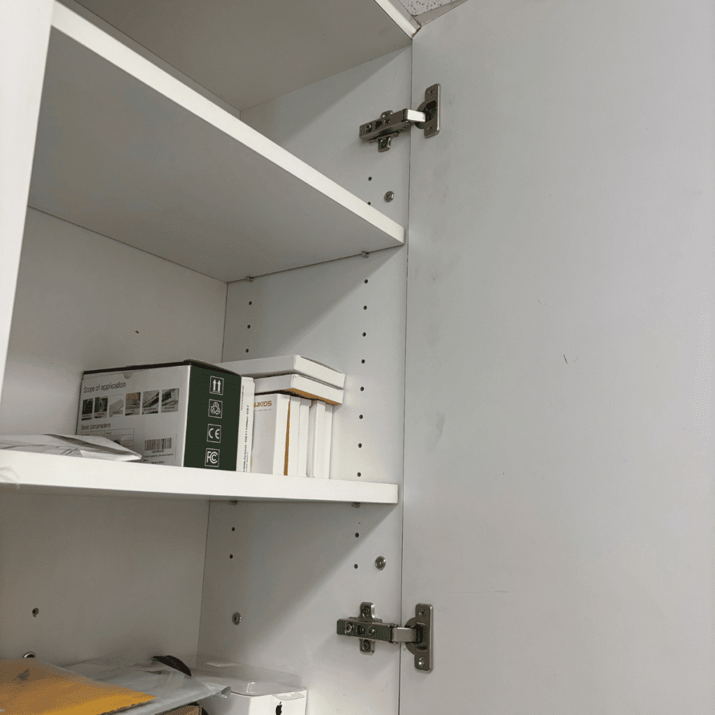 New cabinet hinge being installed on kitchen cabinet