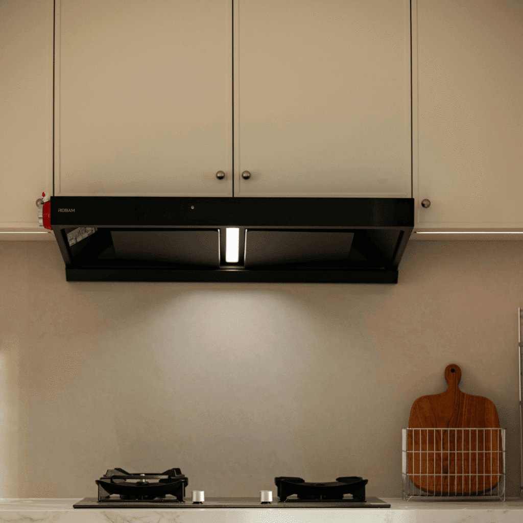 Technician installing exhaust fan in kitchen ceiling