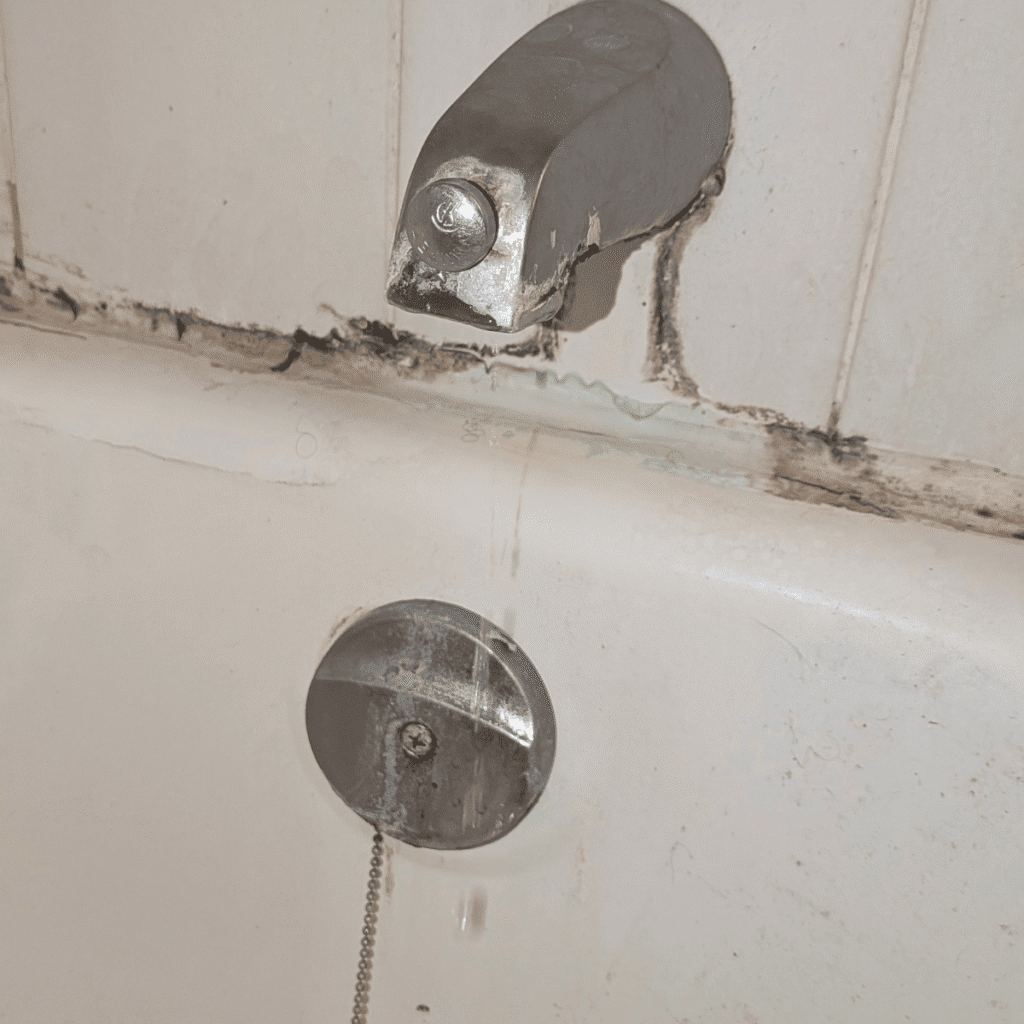 Old faucet being removed during replacement process