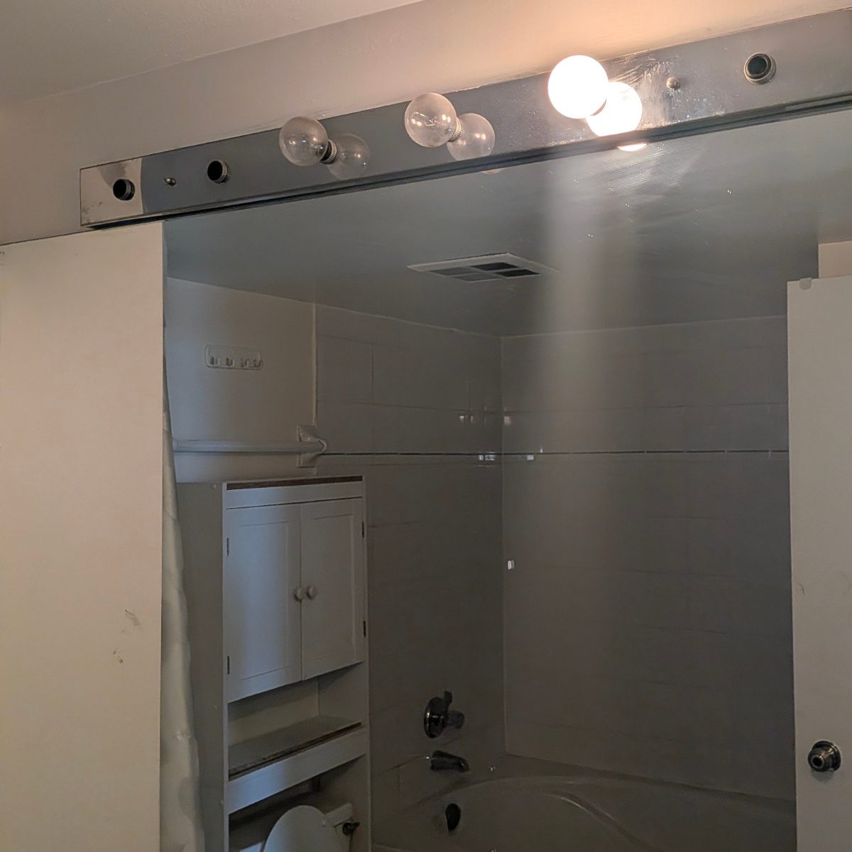 Technician installing modern ceiling light fixture in Toronto home