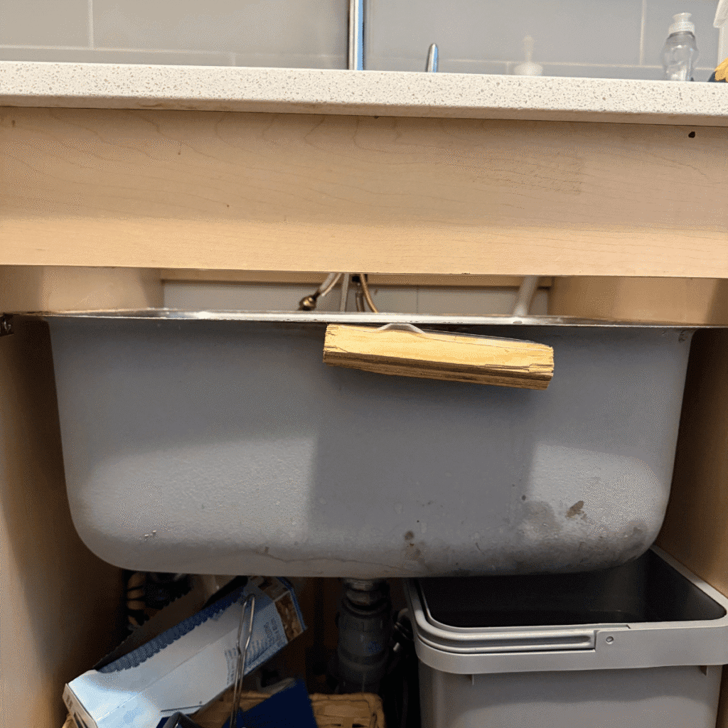 Applying sealant around sink for waterproof finish