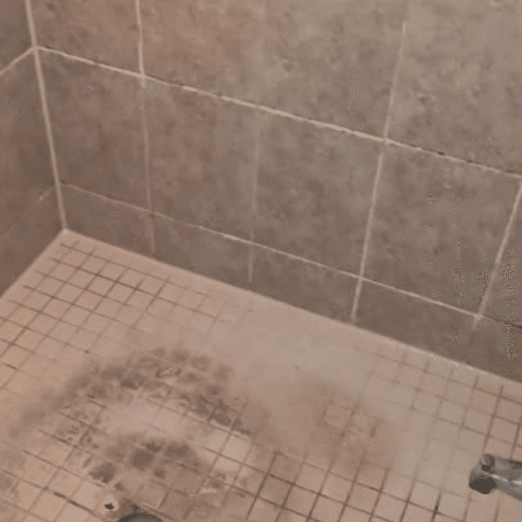 Applying caulking to seal gaps in bathroom or kitchen