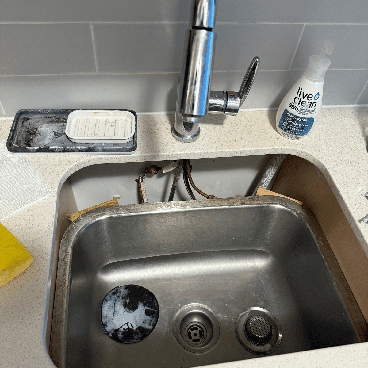 Fallen kitchen sink being repaired and reinstalled