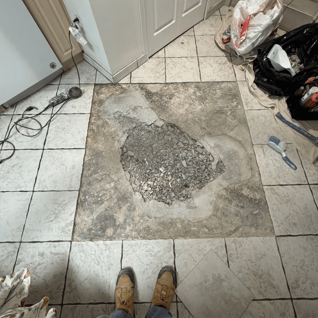 Removing damaged tile carefully without affecting surrounding tiles
