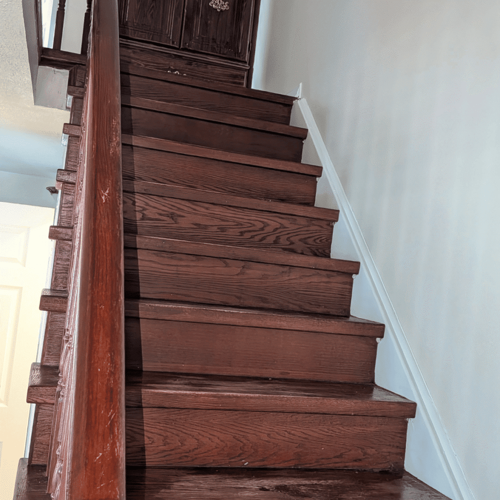 Application of wood stain on stairs to enhance natural appearance