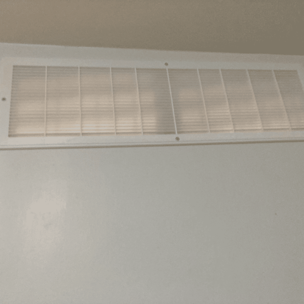 Wall being cut to create opening for air vent