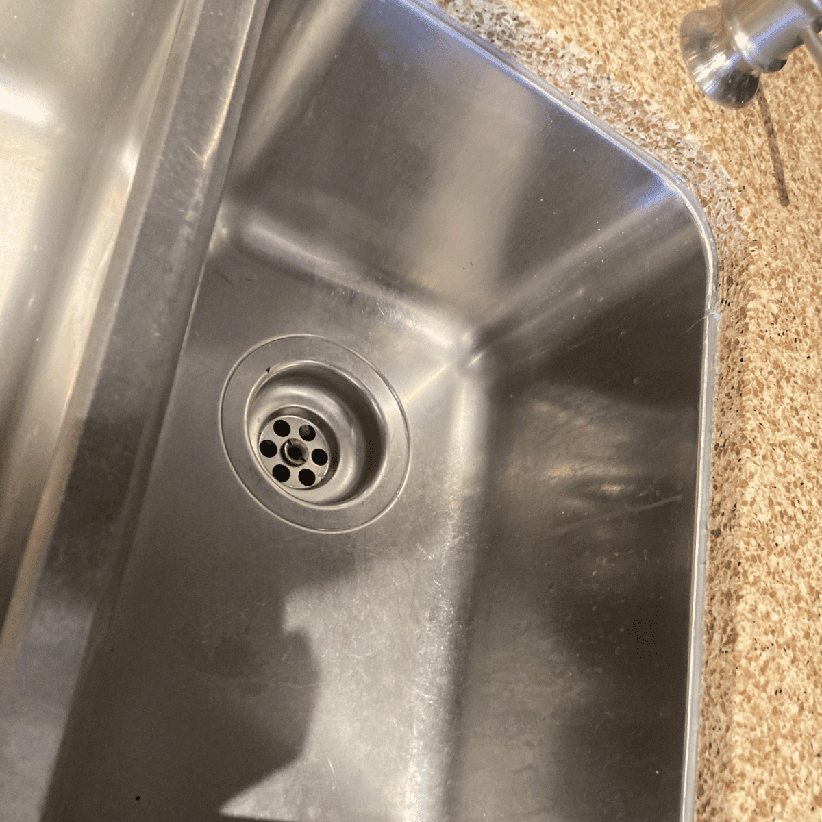 leaking kitchen sink pipe P-trap water damage cabinet