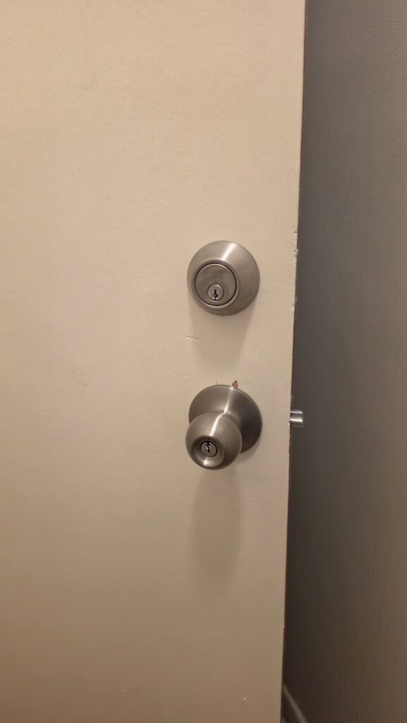 Single-cylinder deadbolt and door knob ready to be replaced with a keypad smart lock