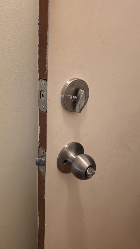 Smart lock installation Richmond Hill – existing deadbolt and knob on a front door before a keypad upgrade