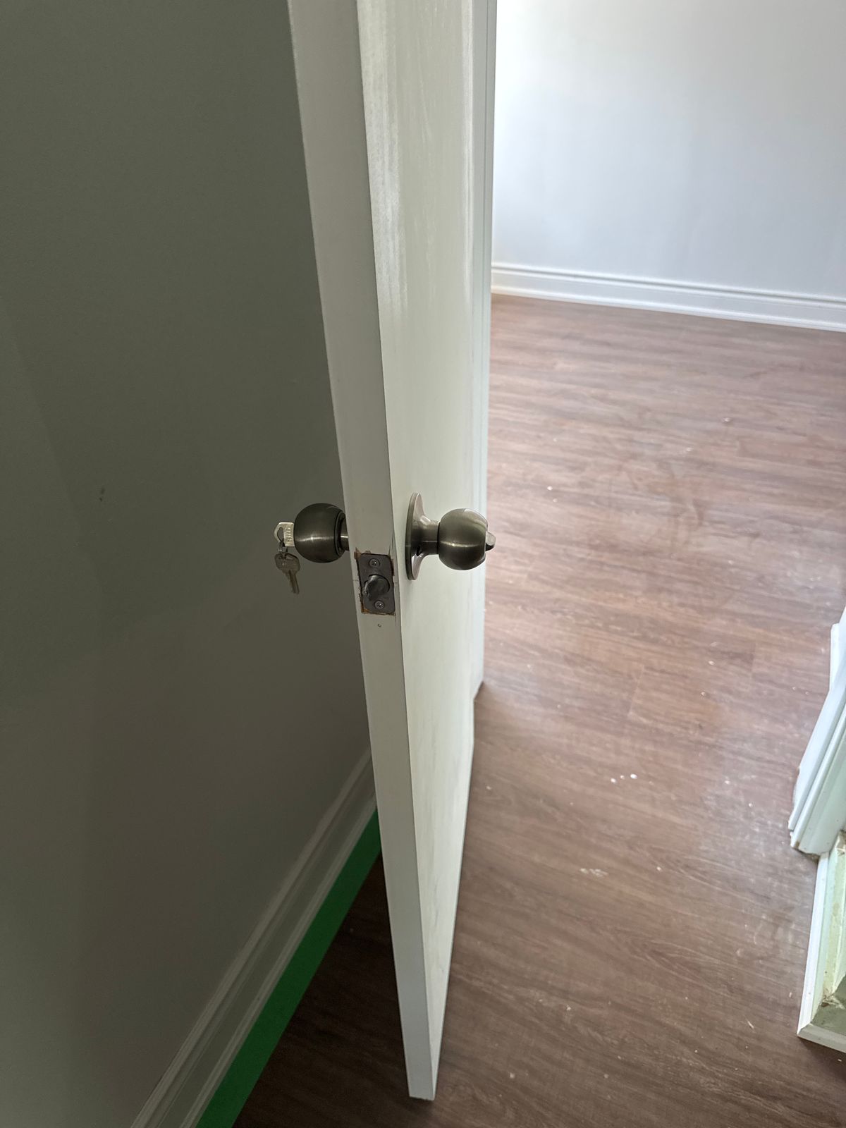 Door handle replacement in Scarborough - handyman installing a new door handle and latch