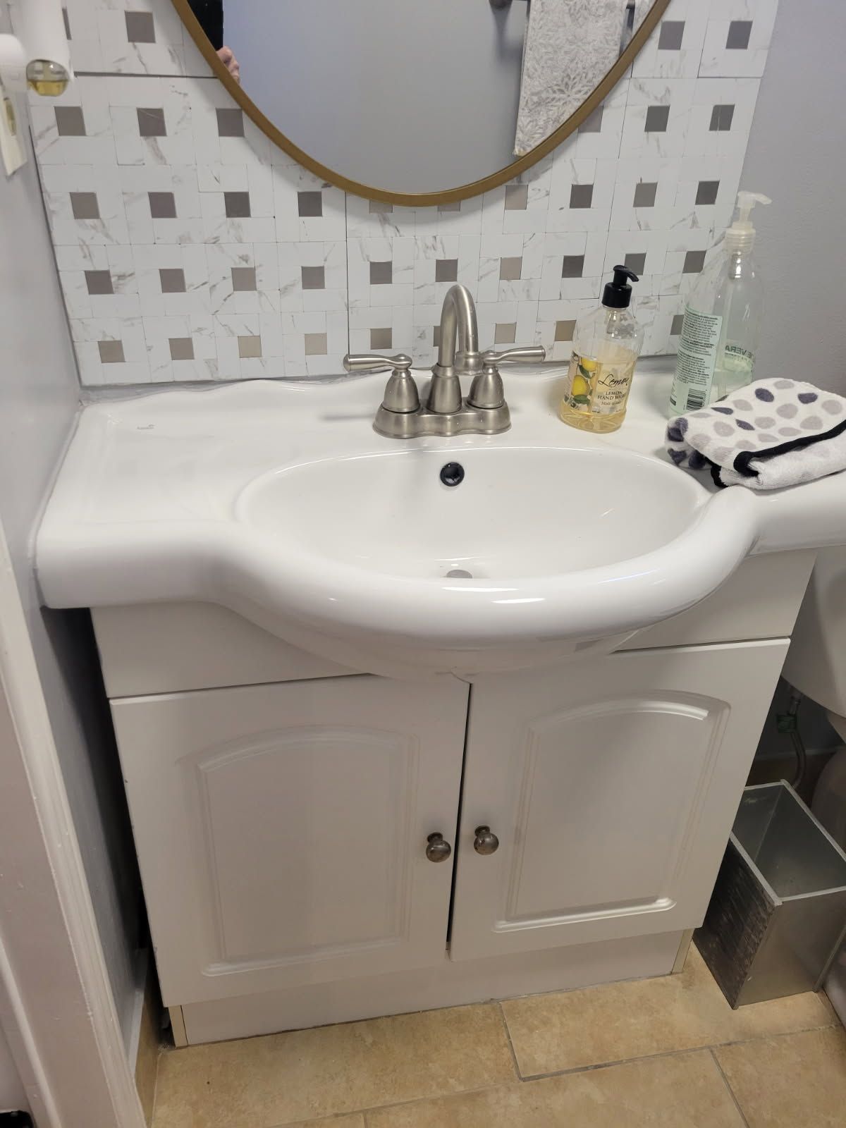 New white bathroom vanity with sink and faucet installed