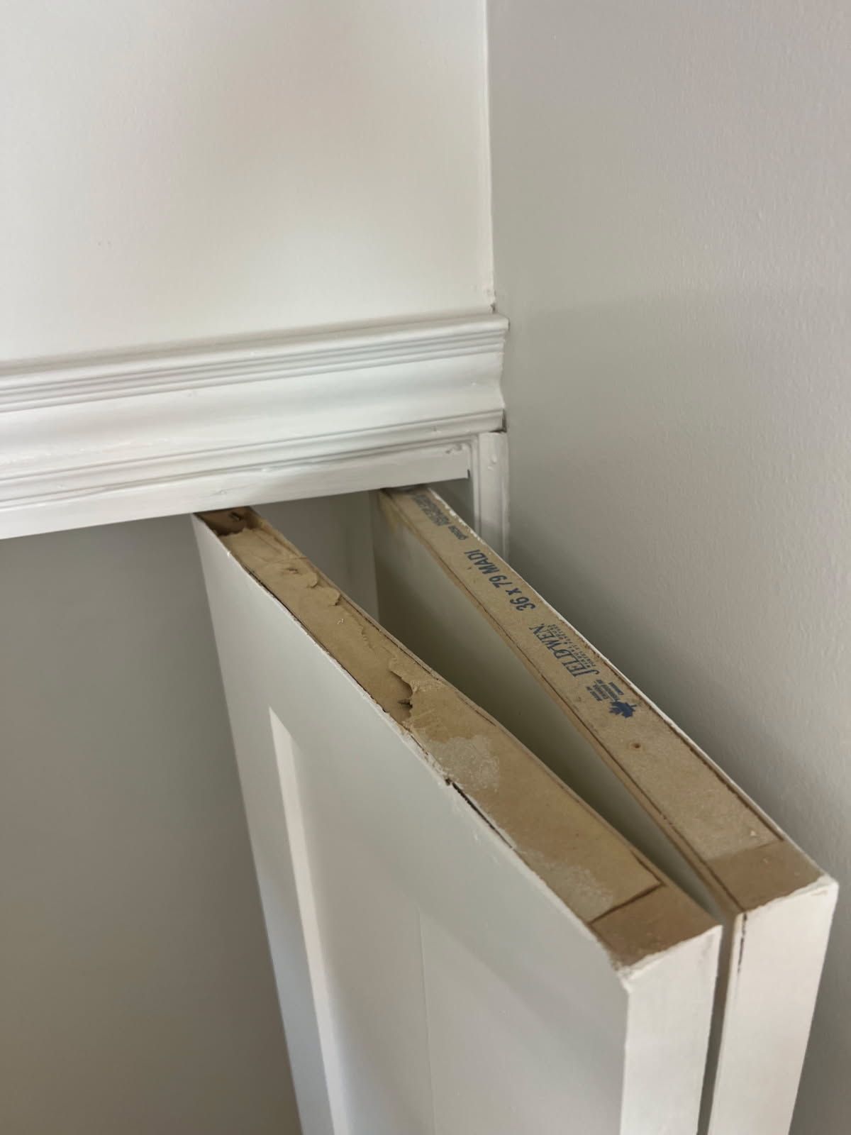 Closet door repair Markham – closet door panel below the header track before re-hanging