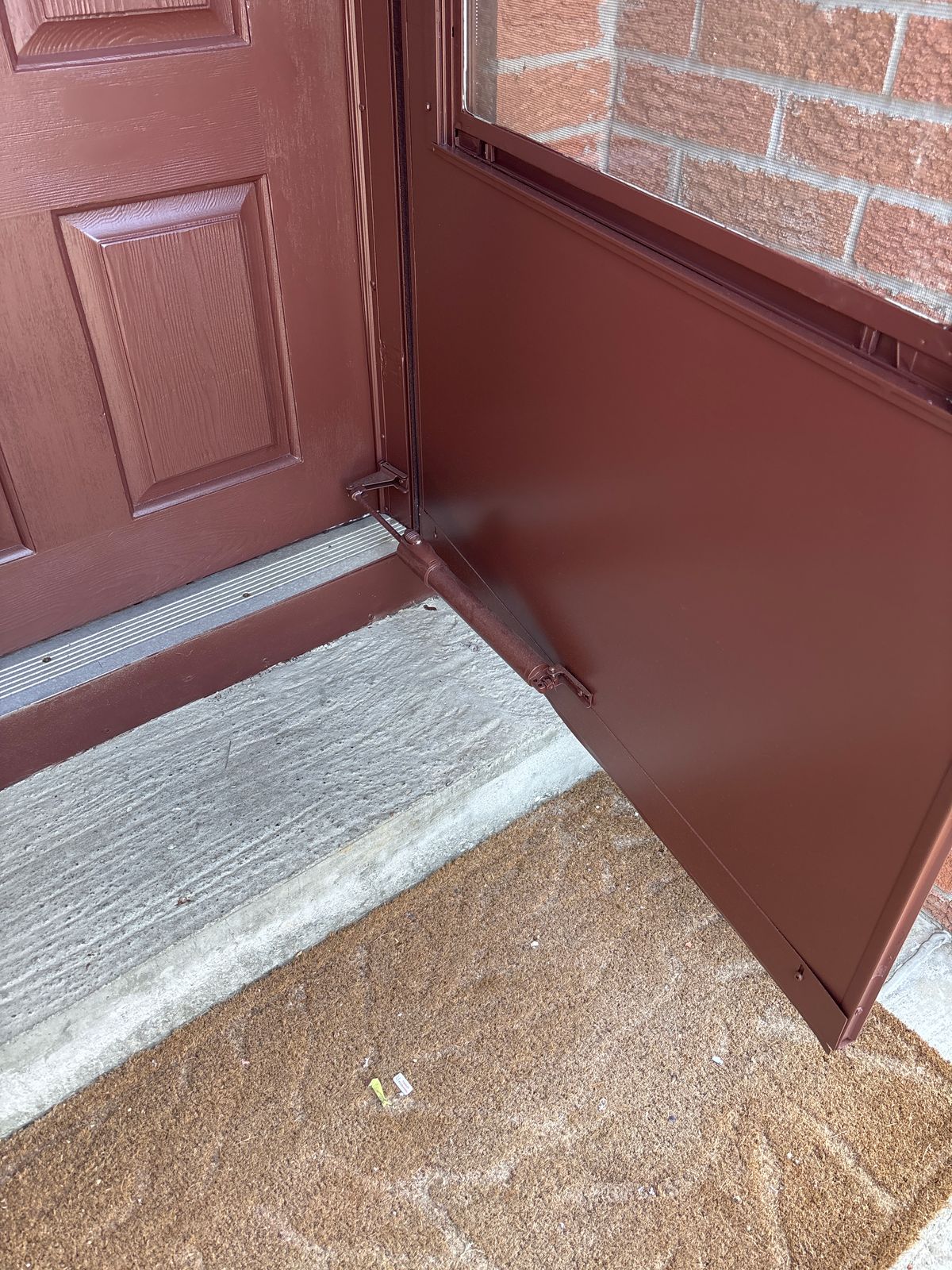 Door closer repair North York – red exterior door with worn closer before repair