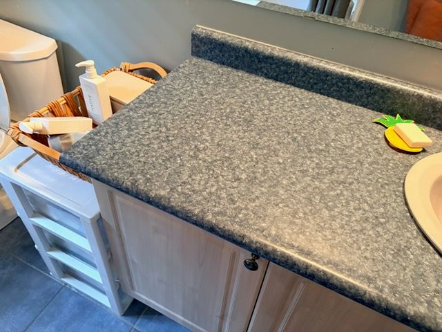 Close-up of vanity cabinet and countertop edge measured for a double vanity replacement