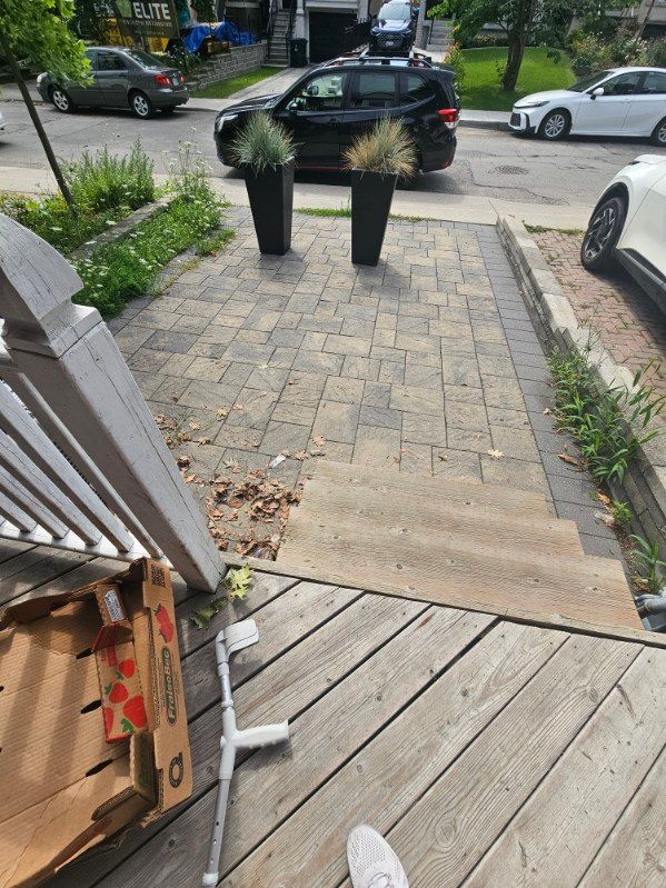 Metal exterior handrail beside interlock front steps