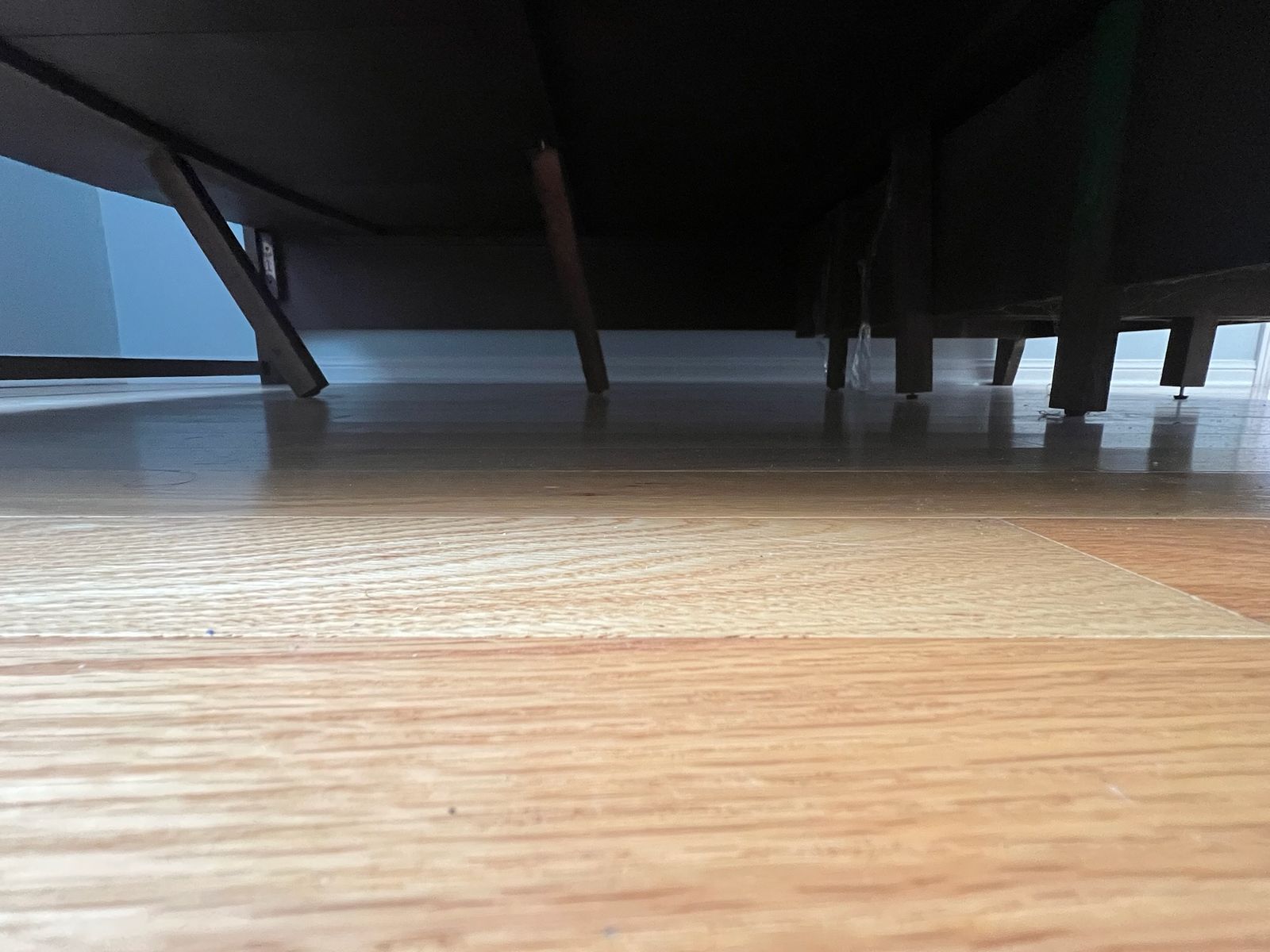 Bed frame legs and support rails inspected under a bed in a Scarborough bedroom