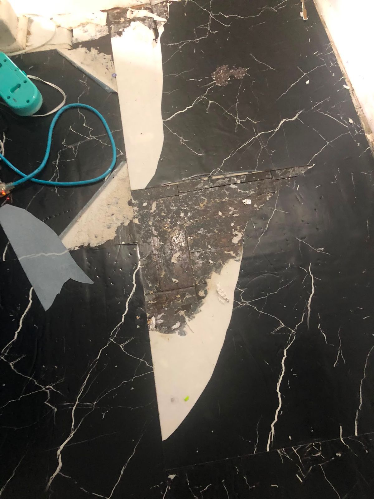 Adhesive residue left on the subfloor after tile removal