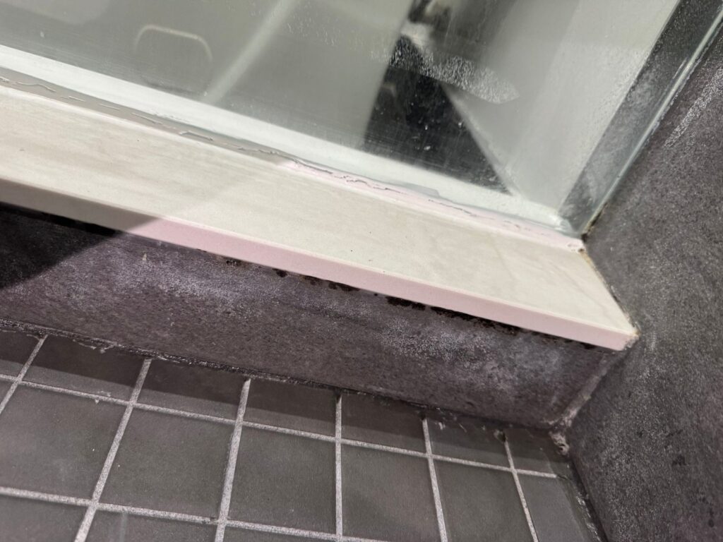 Shower door seal replacement Toronto – glass shower door bottom sweep and threshold on tile