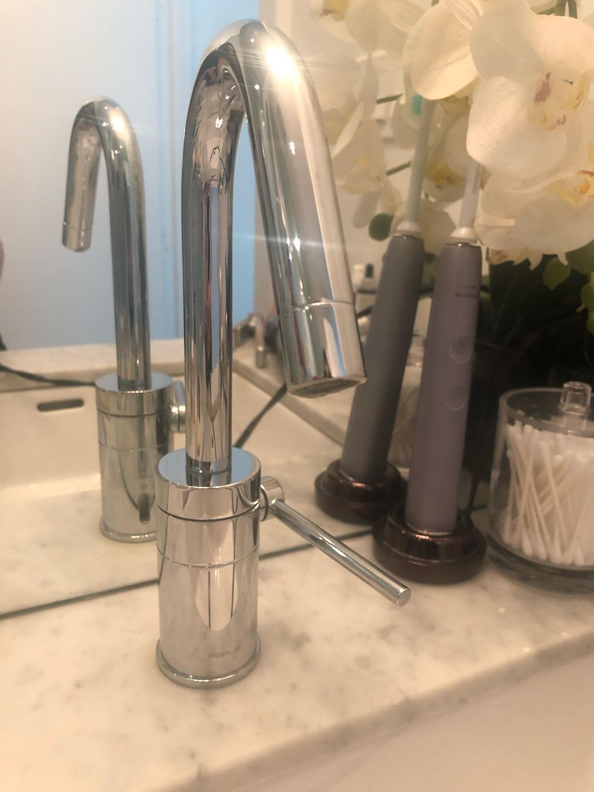 Bathroom faucet and towel bar hardware laid out for a combined bathroom repair visit in Toronto